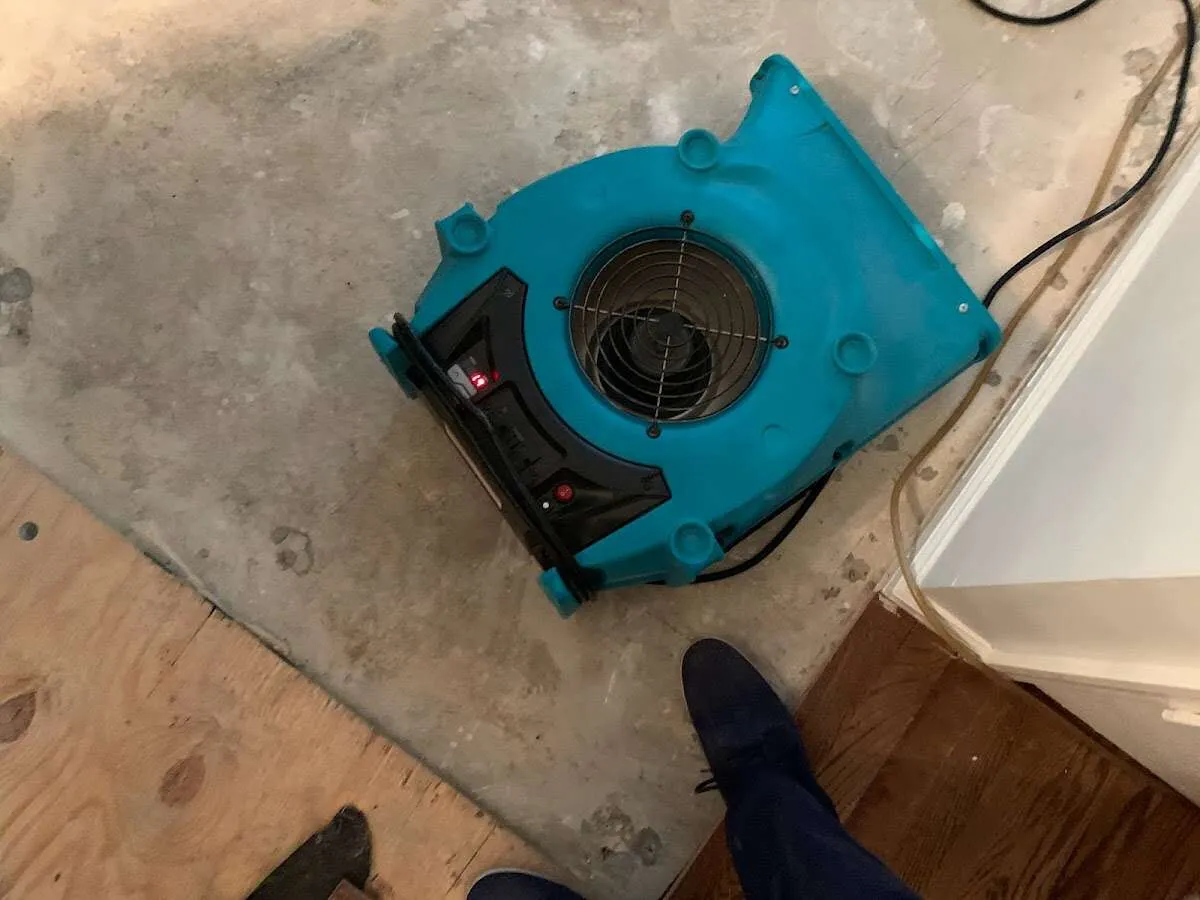 Air mover drying subfloor during Commercial Water Damage Restoration in St. Cloud